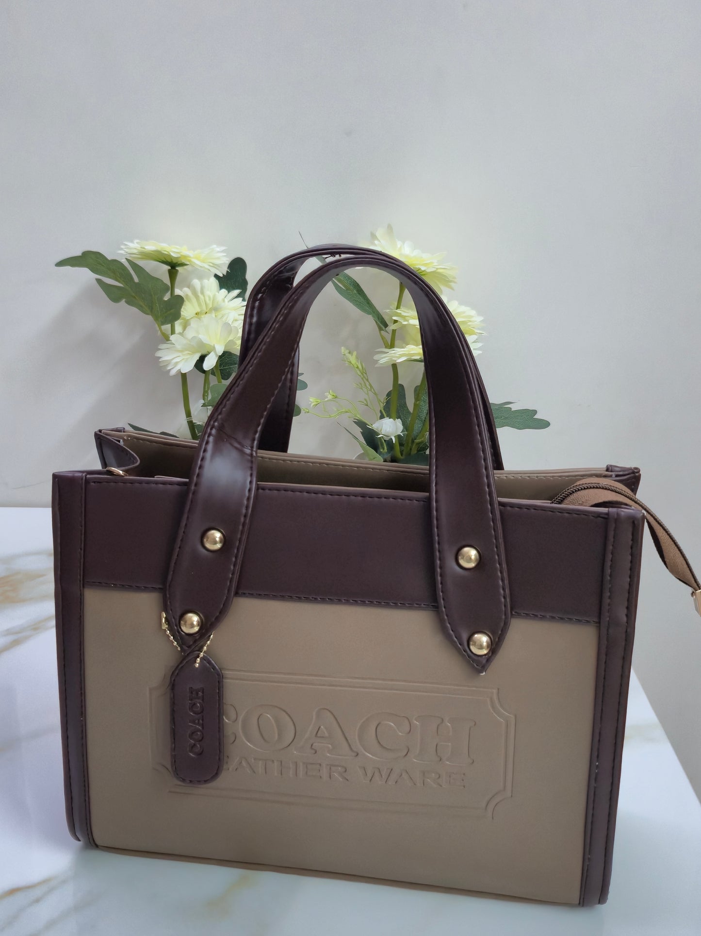 Brown leather handbag with beige interior 