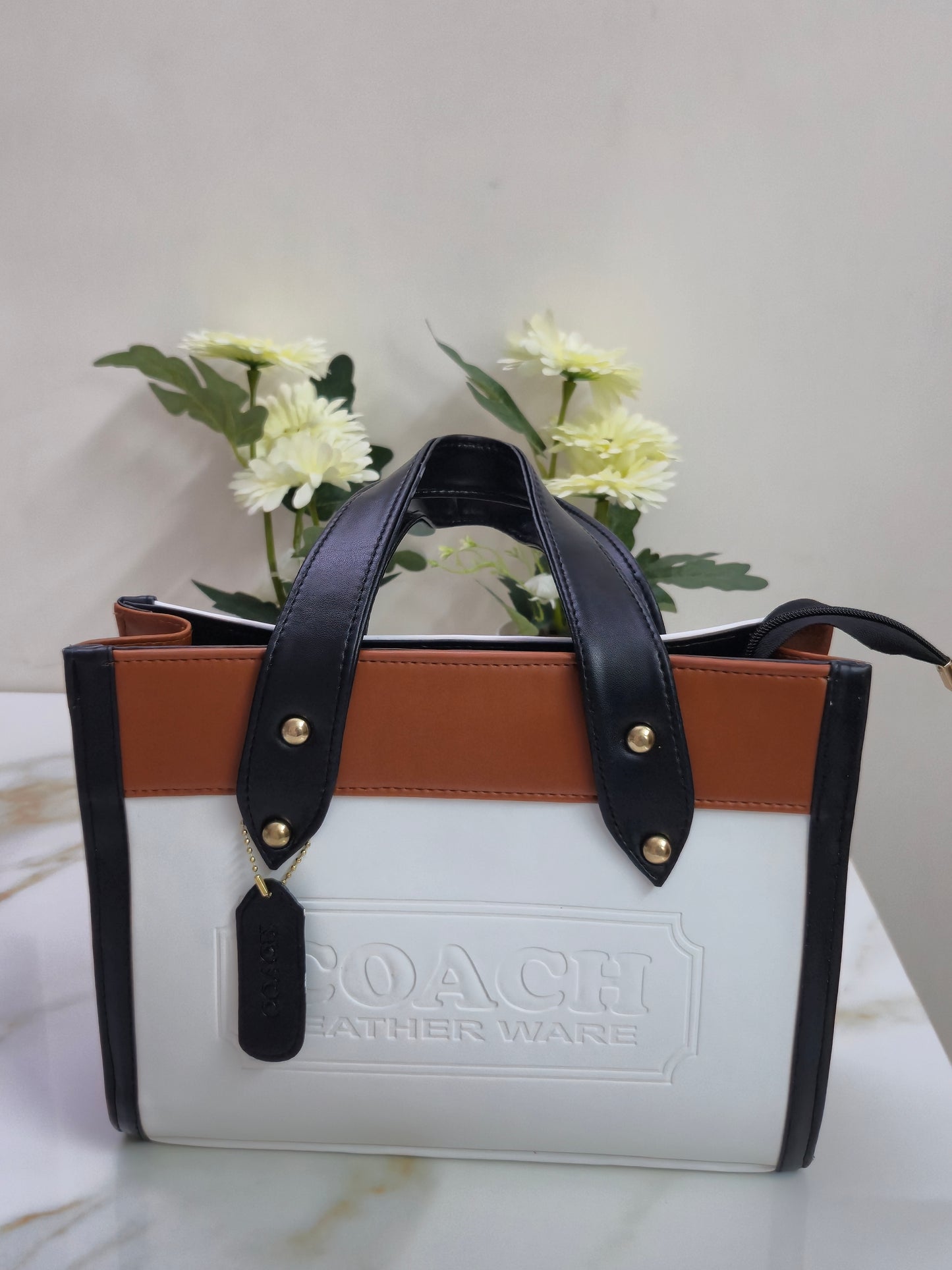 white Tote with leather straps on a white background